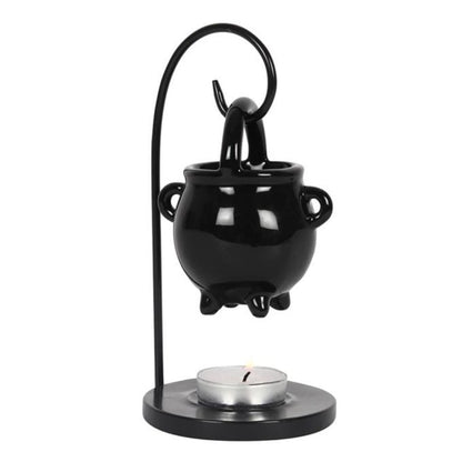Duftlampe in Form eines Hexenkessels, die an einem gebogenen Draht über einem Teelichthalter hängt